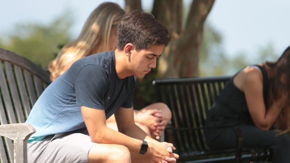 Student praying on campus